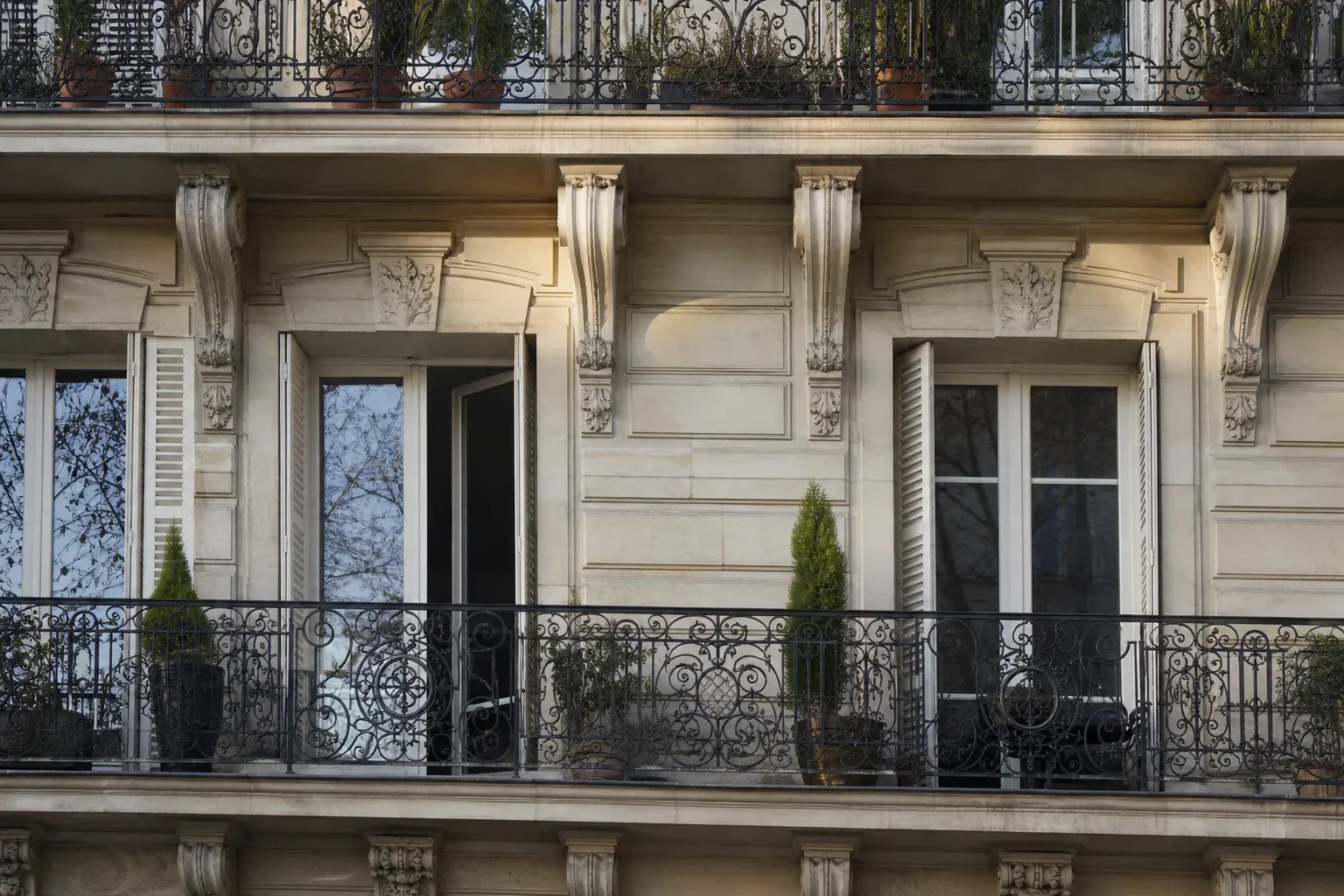 Façade d’immeuble ancien parisien avec balcons en fer forgé, détail rapproché